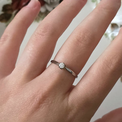 Vintage 18k white gold engagement ring with engravings and a 0.1ct solitaire diamond.